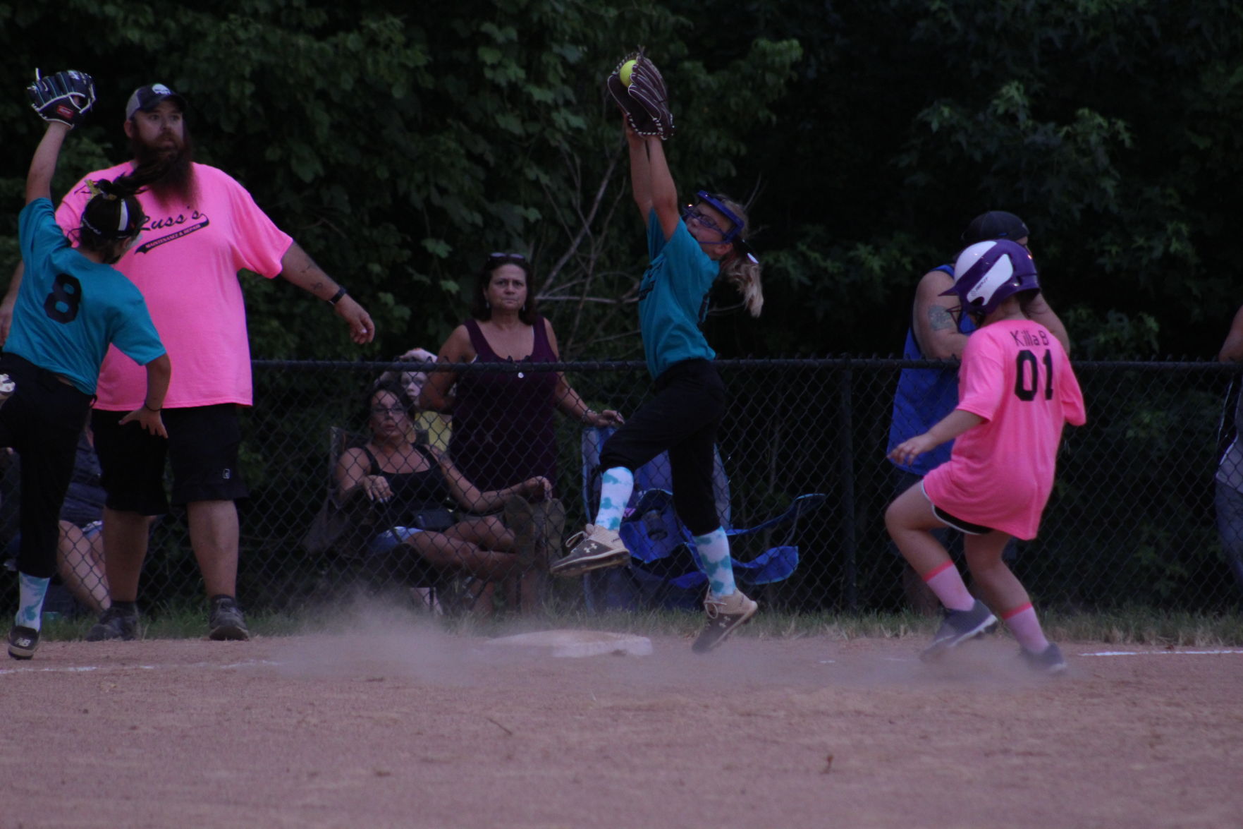 Degraw player jumping up catching ball while Braelyn Conner makes it to third.JPG